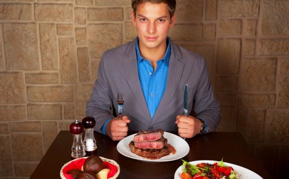 Man at Restaurant Eating Steak