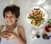 Boy Smiling With Mediterranean Meal