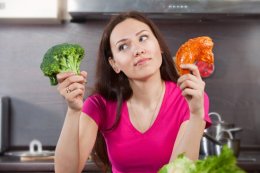 Woman Wondering Whether to Eat Meat or Vegetables