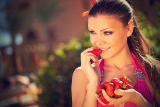 Young Woman eating strawberries